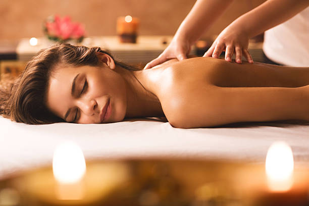 young woman at the spa receiving back massage.